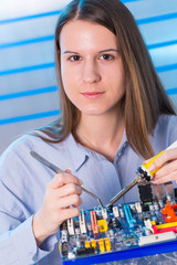 Canvas Print - Young woman fix PC component in service center