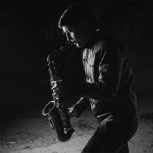 Man Playing Saxophone, With Black Background