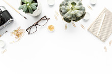 Desk Workspace With Succulent, Retro Camera, Diary, Glasses And Golden Clips On White Background. Flat Lay, Top View