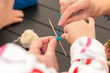  teacher teaches children how to weave a mandala out of thread during the fair in Ukraine