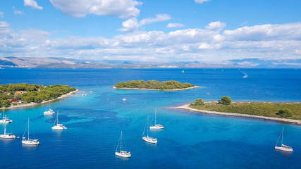 Aerial view of cozy mediterranean island. Blue lagoon, island paradise. Adriatic Sea of Croatia, popular touristic destination. Clear sea water.