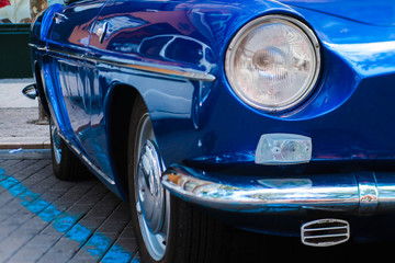 Close-up of front headlight of blue vintage car