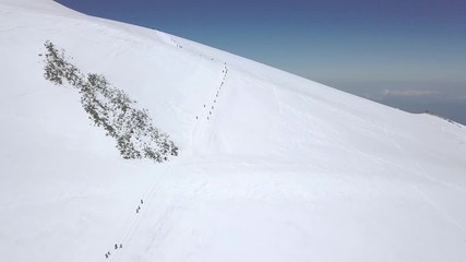 Wall Mural - extreme tourism in snow mountain valley aerial view. hiking mountain in winter