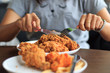 Young woman cutting fried chicken select focus, Fried chicken lunch, Close-up woman hands cutting fried chicken, Eat fried chicken with girlfriend, Select focus fried chicken with blur background