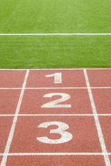 The numbers 1,2,3  on race track in football stadium.