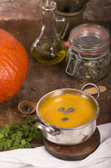 Poster - pumpkin soup on rustic wooden background