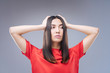 © zinkevych - Poor student. Worried beautiful thoughtful student standing alone and touching her head with two hands while having no idea what to do with her life