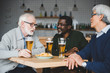 © LIGHTFIELD STUDIOS - senior friends drinking beer in bar