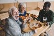 © LIGHTFIELD STUDIOS - senior friends drinking beer with pizza