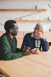 © LIGHTFIELD STUDIOS - senior friends sitting at bar
