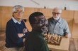 © LIGHTFIELD STUDIOS - senior friends playing chess