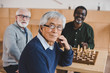 © LIGHTFIELD STUDIOS - senior friends playing chess