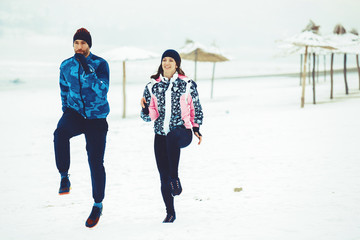 Wall Mural - Enthusiastic Love Couple Exercising Outdoors.