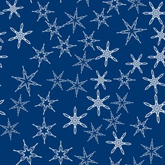 Wall Mural - Seamless pattern with abstract colorful snowflakes on blue background. Chaotic, random, scattered winter motives. Vector illustration.