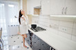 © AS Photo Family - Brunette girl, wear at shirt and underwear cooking at the white kitchen.