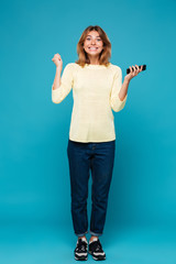 Sticker - Full length image of Happy woman in sweater rejoice