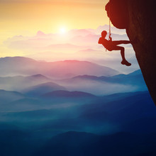 Silhouette Of Climber Girl On A Cliff