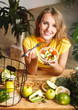© proimagecontent - Attractive, slim girl eating vegetable salad at the wooden table full of healthy nutritious food