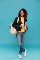 Wall Mural - Full length image of smiling african woman in leather jacket