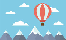 A View Of A Large And Hot Air Balloon Flying Between Clouds In A Blue Sky Above Mountain Peaks