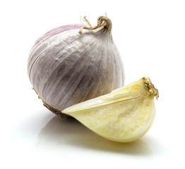 One whole and sliced quarter of solo garlic isolated on white background.