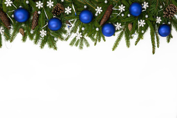 christmas upper decoration with blue balls, stars and cones on white background.