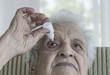 © berna_namoglu - senior woman applying  eye drop on her eye