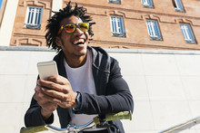Afro Young Man Using Mobile Phone And Fixed Gear Bicycle.