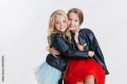 Portrait Of Little Girls With Curly Hairstyle Hugging On The
