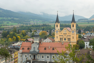 Mesmerising top view on the Parish church in the autumnal city Brunico from the tower of Bruneck castle in Alto Adige, Italy, Europe