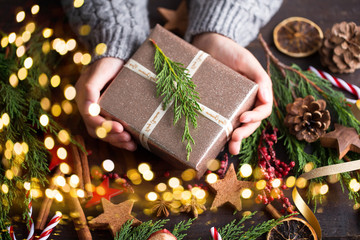 Woman hands making Christmas day gifts.