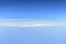 Clouds On The Blue Horizon As Background With Copy Space On Top And Bottom
