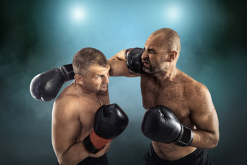 Wall Mural - Two professional boxers, athletes in dynamic boxing action on th