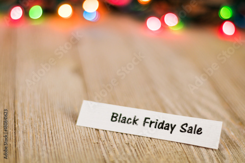 Black Friday Sale Concept On Wooden Board And Colored Lights