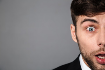 Poster - Cropped portrait surprised brunette man looking at camera,