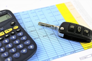 An concept Image of a car key, calculator and a Business paper