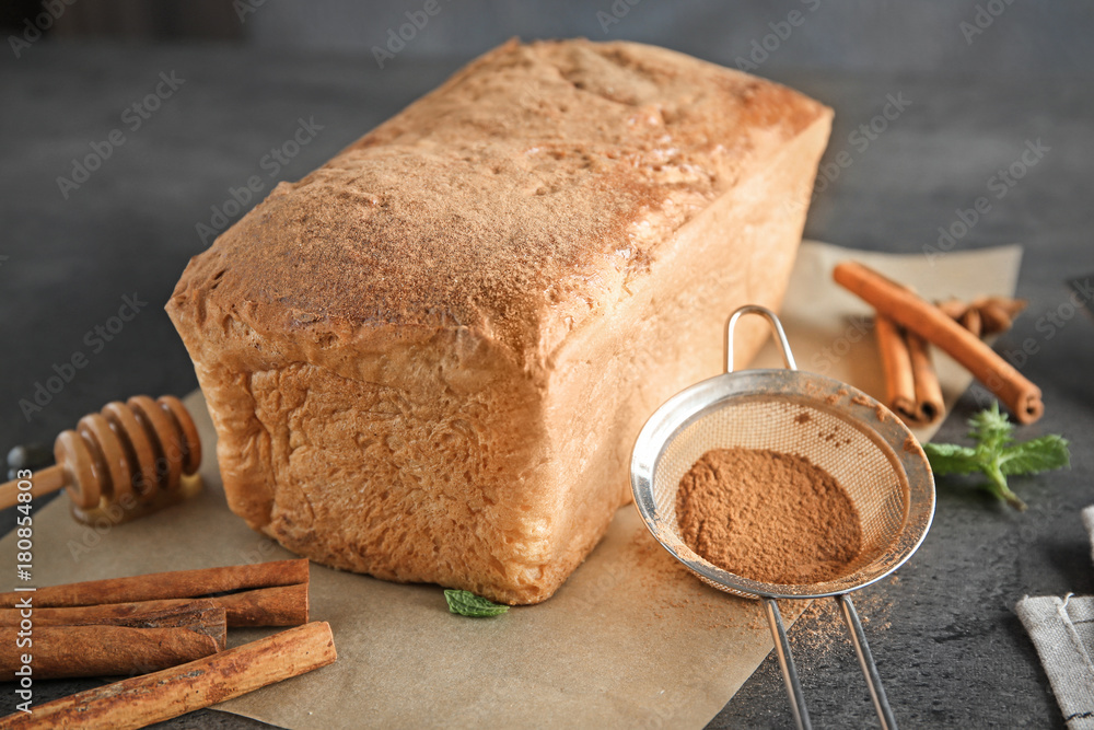 Delicious cinnamon cake on table