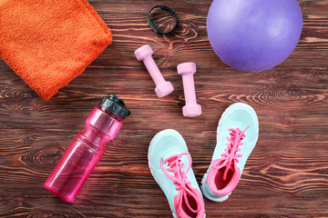 Wall Mural - Composition with towel and sport equipment on wooden background