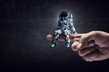 Wall Mural - spaceman on finger. mixed media