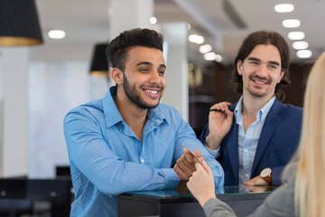 Wall Mural - Happy Smiling Business Man Give Credit Card To Female Shop Assistant Paying For Clothes, Successful Businessmen In Luxury Suits Store