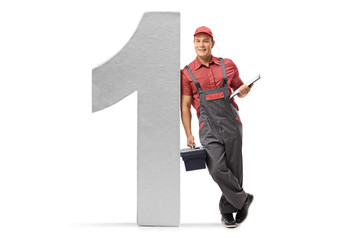 Wall Mural - Repairman with a clipboard and a toolbox leaning against a cardboard number one