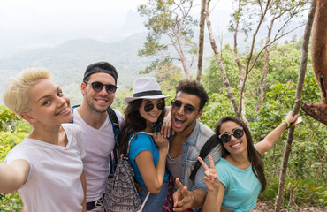 Wall Mural - people group take selfie photo over beautiful mountain landscape, trekking in forest, mix race young