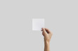 © OB production - Right hand holding square paper in the right hand. Leaflet presentation.
