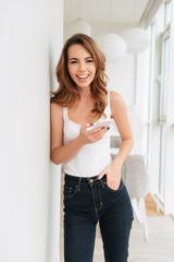 Poster - Amazing smiling young lady standing near window chatting