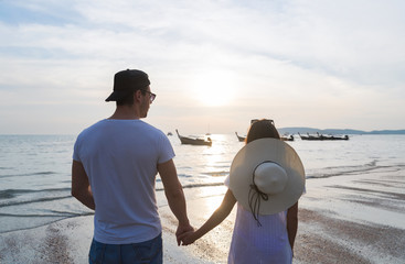 Wall Mural - Couple Beach Summer Vacation, Man Woman Holding Hands Sunset Young Guy Girl Back Rear View Sea Ocean Holiday Travel