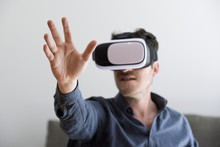Mid Adult Man Using Virtual Reality Headset