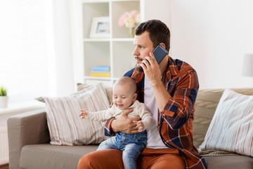 Poster - father with baby calling on smartphone at home