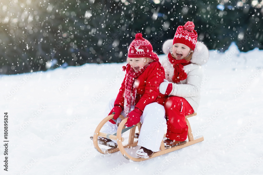 Kids on sleigh. Children sled. Winter snow fun. - obrazy, fototapety, plakaty 