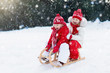 © famveldman - Kids on sleigh. Children sled. Winter snow fun.