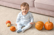 © Africa Studio - Adorable baby with pumpkins indoors